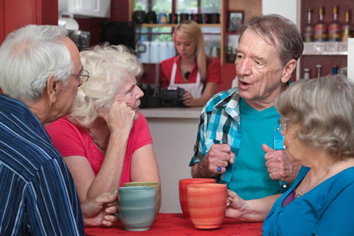 A group of senior citizens enjoying a cup of tea