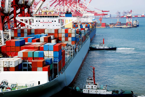 Cargo ship and tugs