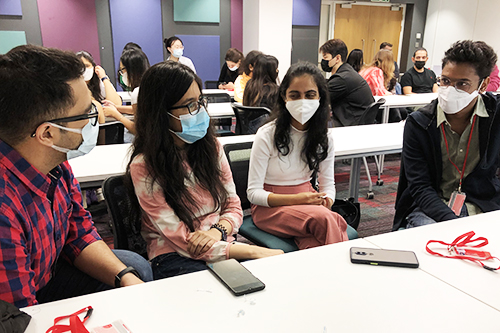 Four students talking with each other during the workshop