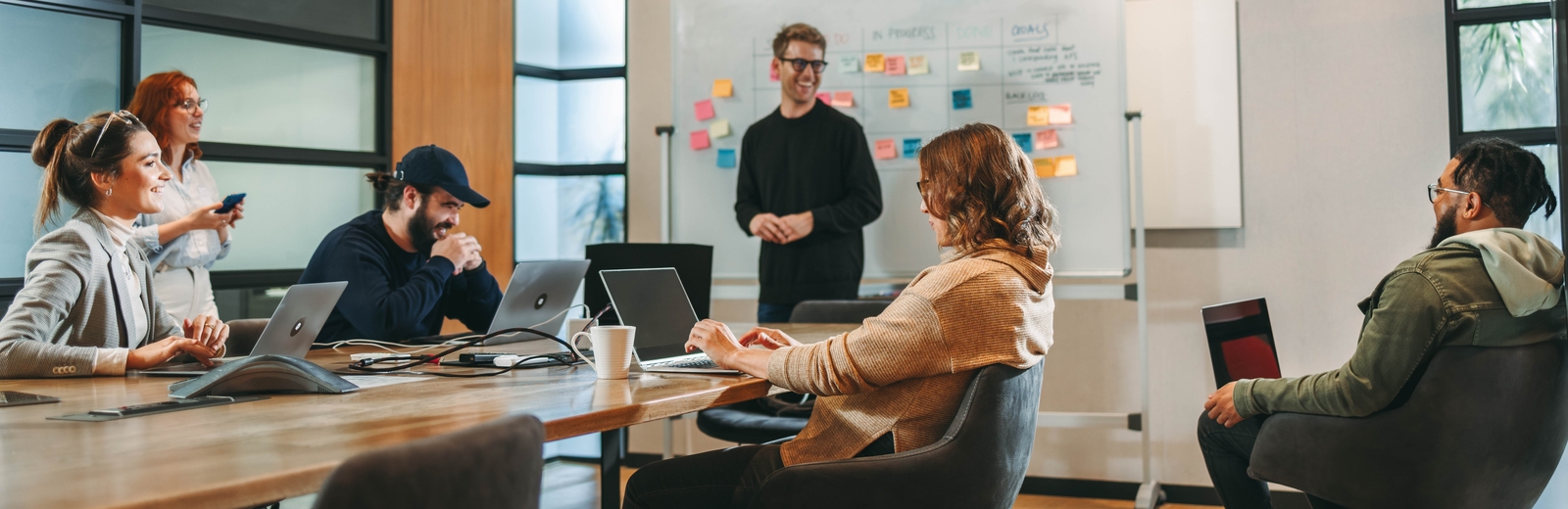 Diverse team collaborate in an office meeting room.