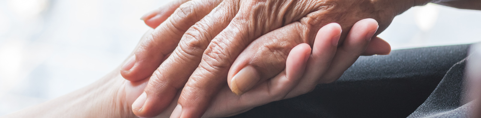Young and old hands clasped
