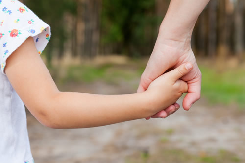 Mother and daughter holding hands