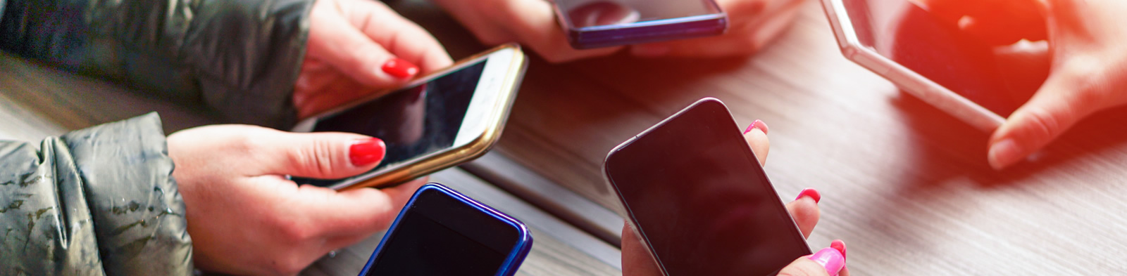 A group of people holding their mobile phones