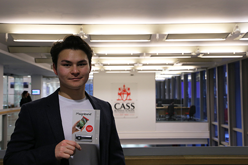 man standing in front of cass business school logo