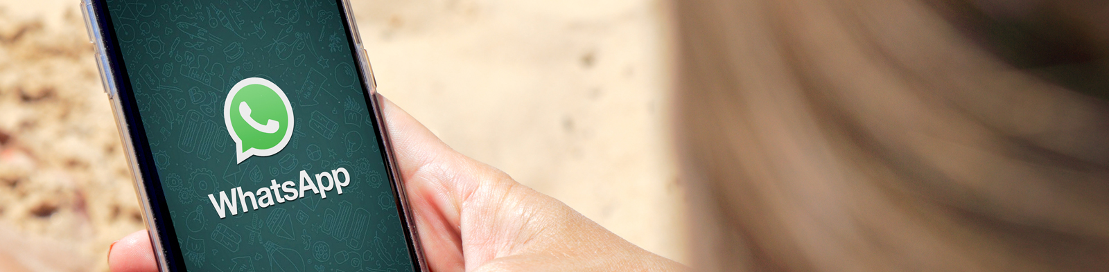 Woman with Whatsapp on her phone