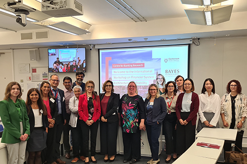 IWFSAS presenters lined up in front of a projector screen