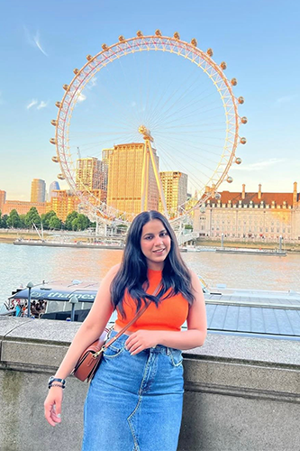 Photo of Anamika on Embankment with the big wheel behind her