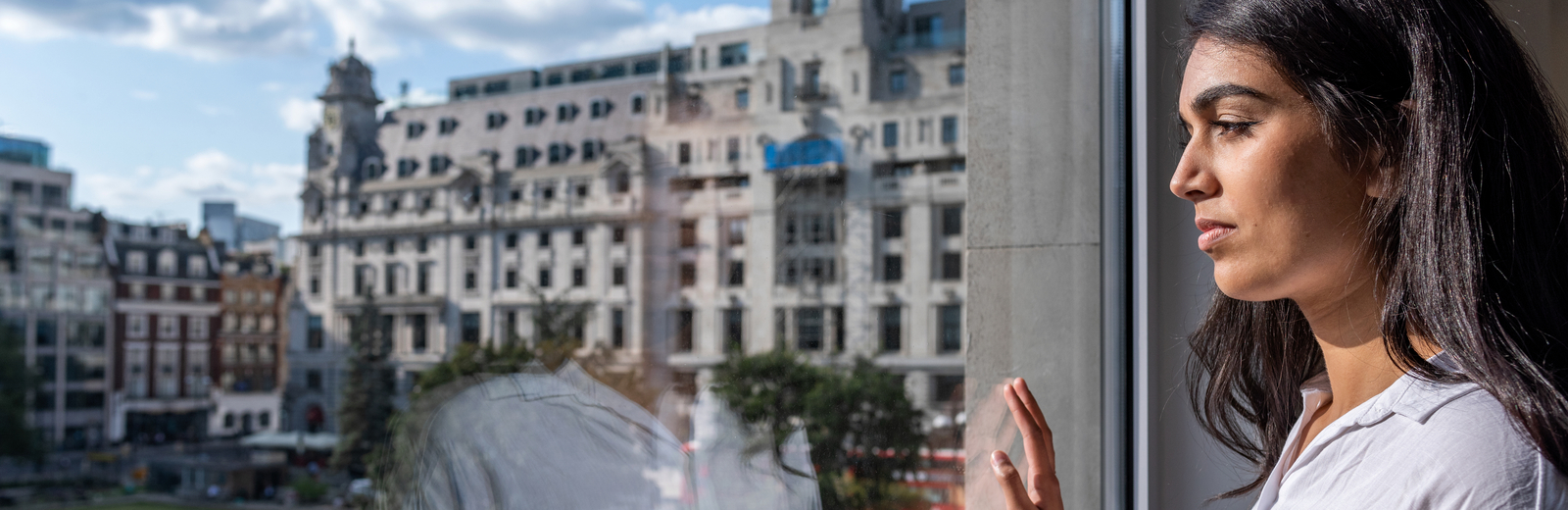 Young woman looking out of a window at Finsbury Square