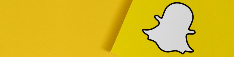 Snapchat logo on yellow paper.