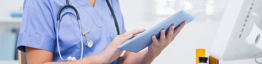 Young female doctor using iPad
