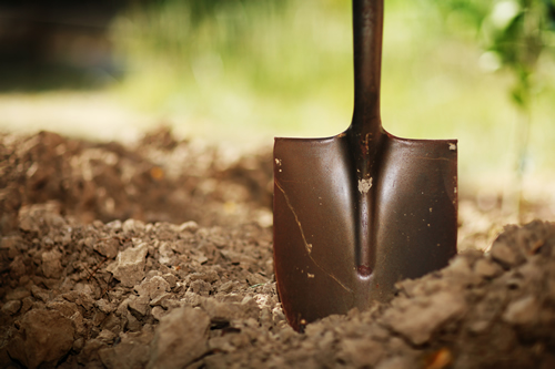 Spade digging into earth