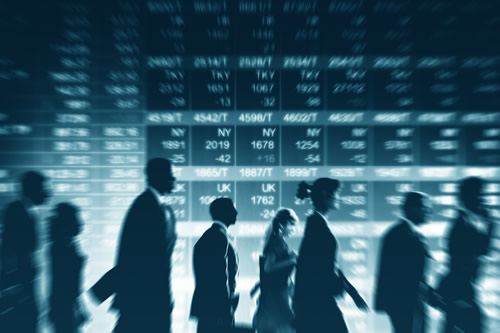 Traders against a background of share prices