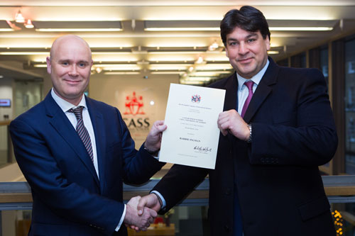 Prize winner Barrie Ingman receives his certificate of merit from WCIB Liveryman Omiros Sakiras