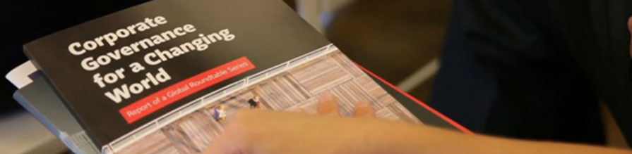 An audience member holds a report written by collaborators from Cass Business School and public interest law firm Frank Bold.