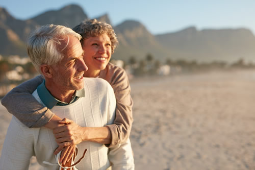 Retired couple having fun on the beach
