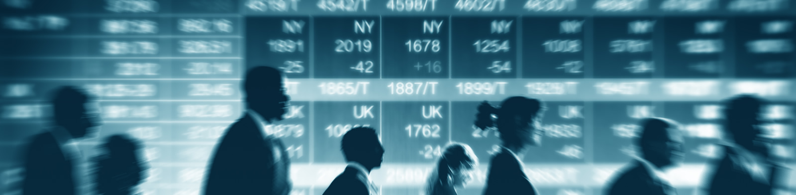 Traders against a background of share prices