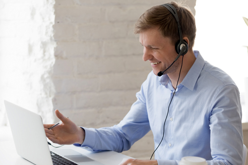 man in front of laptop on conference call