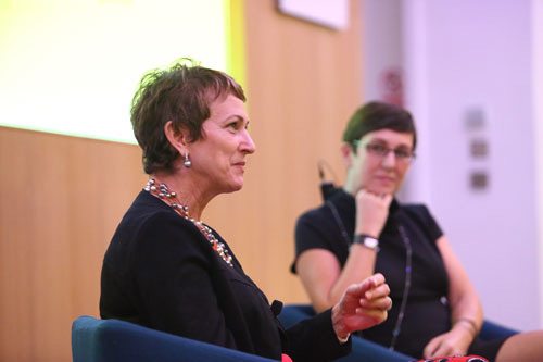 Dame Inga Beale speaking at a talk next to Dr Canan Kocabasoglu Hillmer