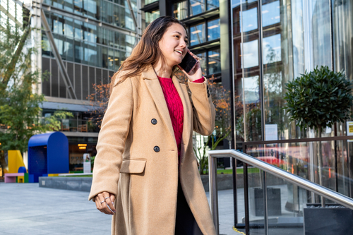 Young white woman on her phone in Shoreditch.