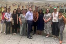 The DEI team gathered outside in the summer.