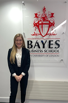 Simone Bethel standing in front of Bayes sign
