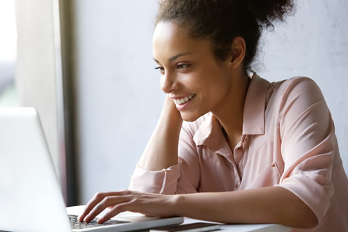 Woman playing game on computer
