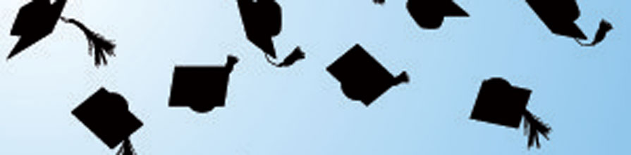 Graduates throw their mortar boards in the air in celebration.