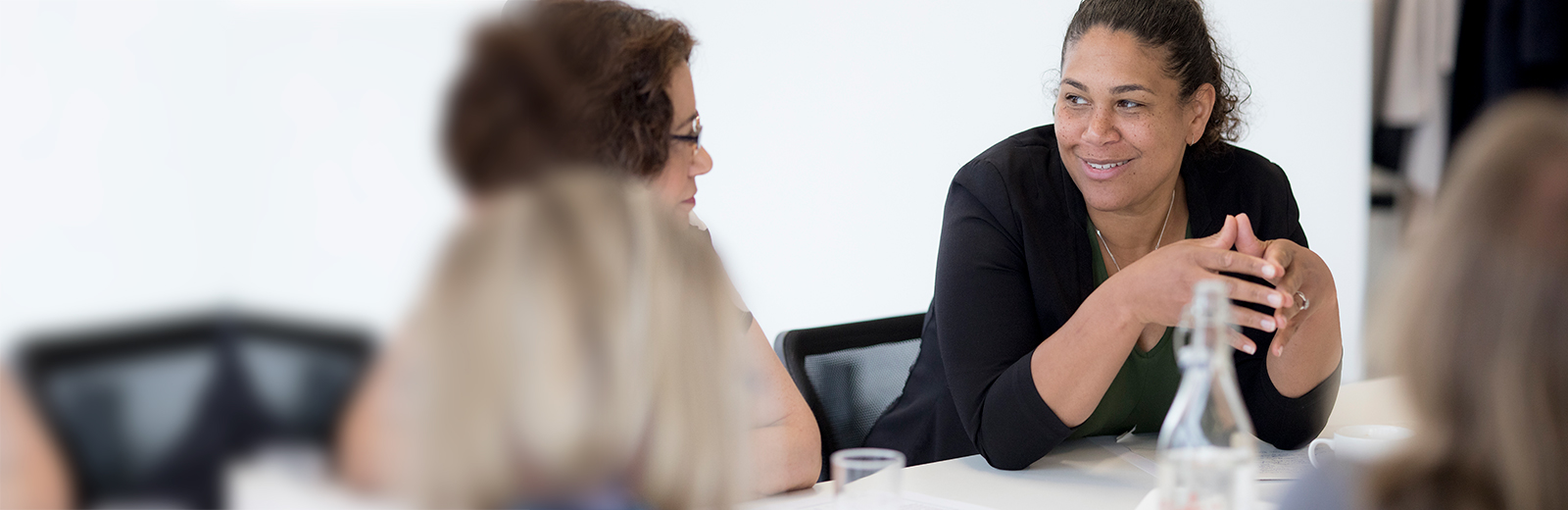 Woman sitting down in discussion at a conference