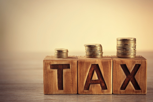 Wooden blocks spelling the word TAX