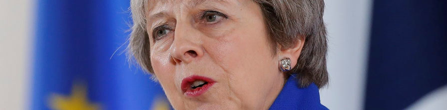 Theresa May looks in to the distance while delivering a speech.