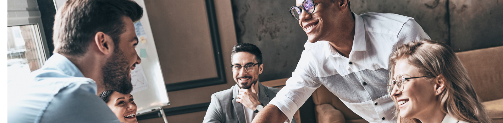 Smiling colleagues shaking hands in a boardroom