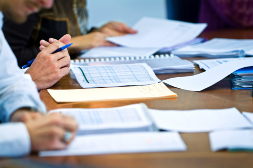 Two people looking over papers and documents