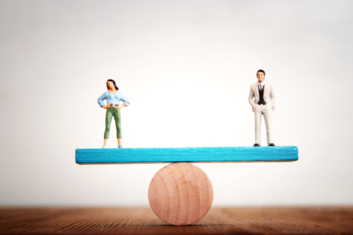 Figures balance on a see saw