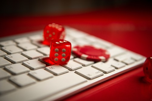 Die and poker chips on a computer keyboard