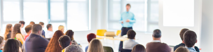 Blurred man giving business meeting to crowd