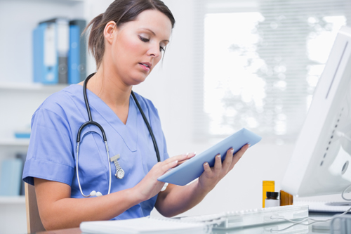 Young female doctor using iPad