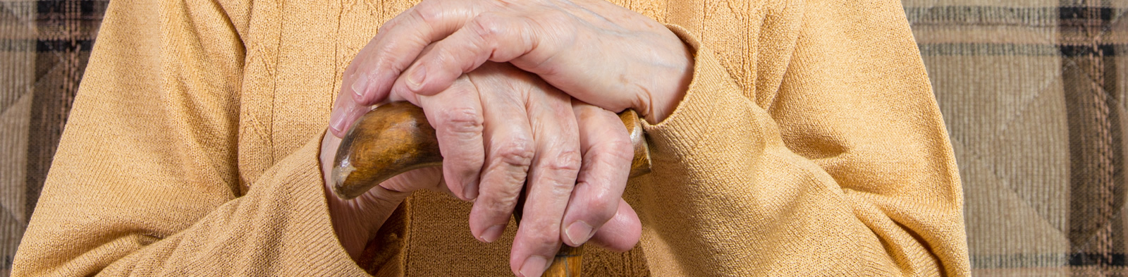 A pensioner holding a cane