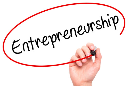 A hand writing the word Entrepreneurship