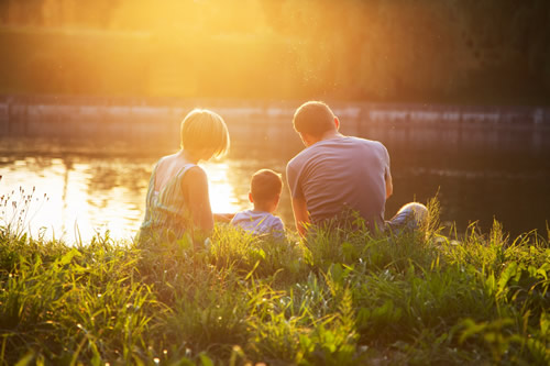 A family sat by a lake