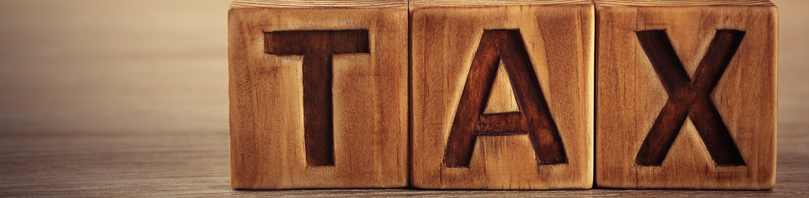 Wooden blocks spelling the word TAX