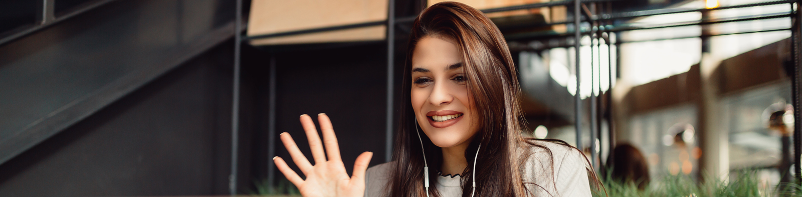 woman smiling into a video conference call on laptop