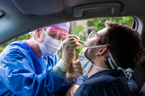 Doctor taking a swab to test for COVID-19