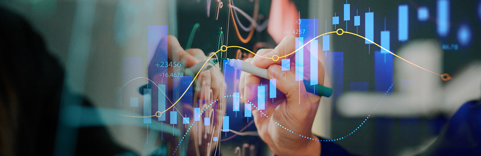 Close up of a researcher's hand writing complex patterns on a reflective digital screen. Digital overlay of charts rising and falling.