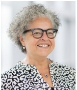 Photo of Tammy who is wearing glasses and a black and white top