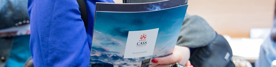 Woman holding conference brochure at Cass Innovate 2017