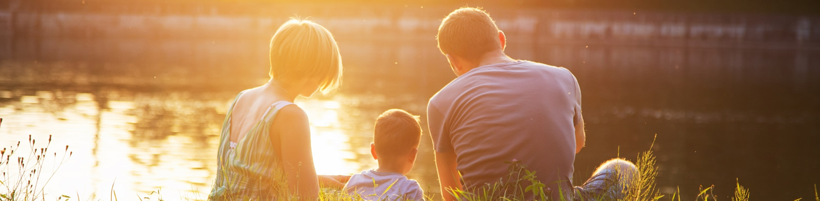 A family sat by a lake