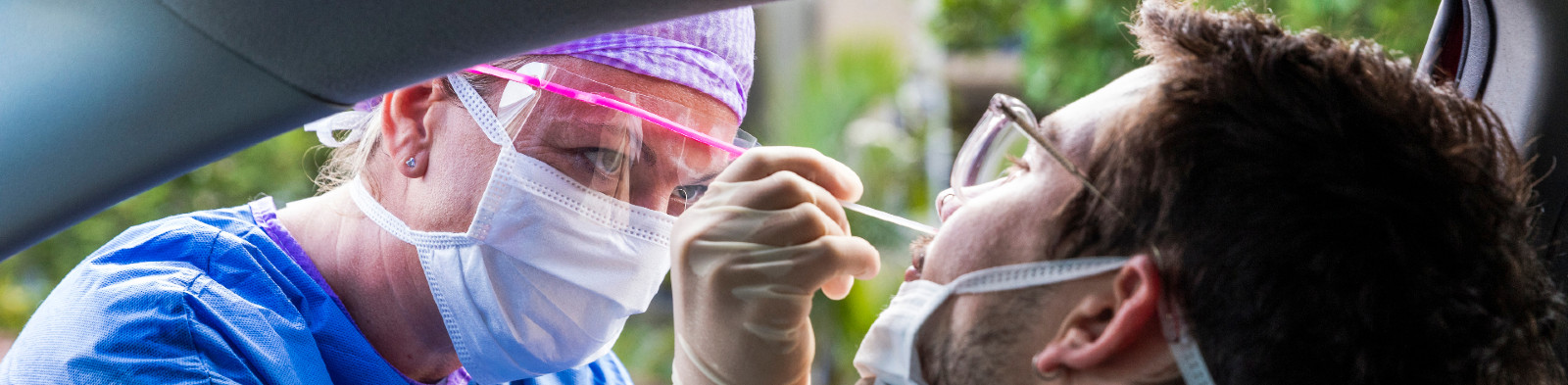 Doctor taking a swab to test for COVID-19
