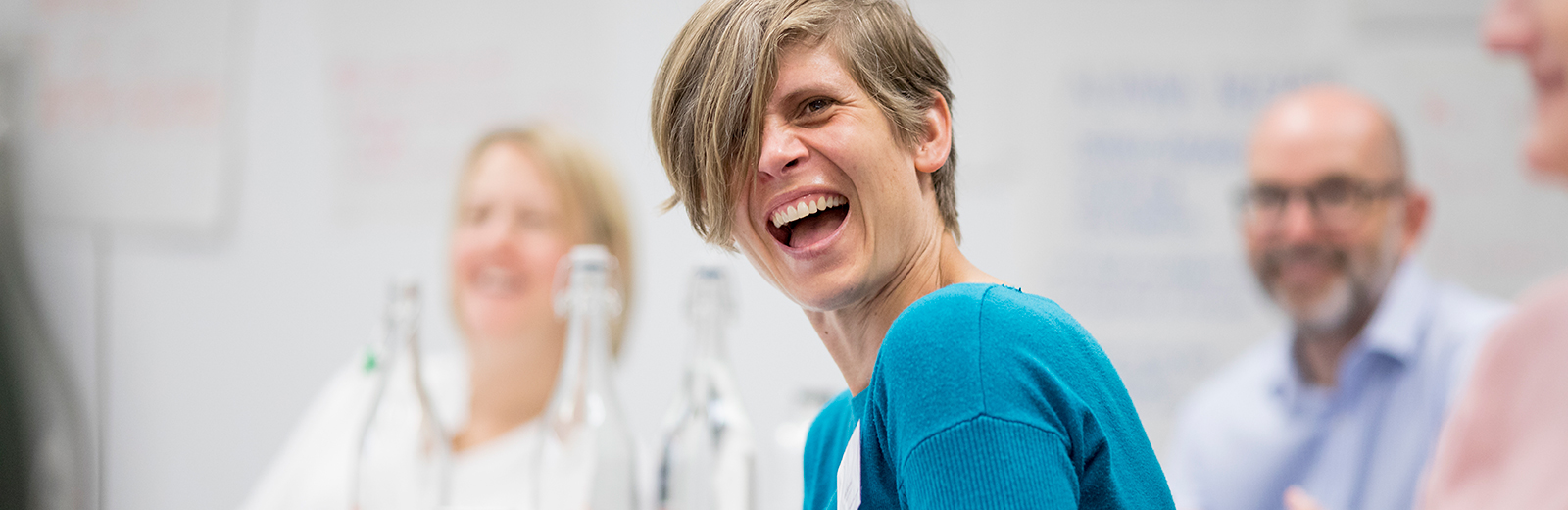Woman laughing in a conference 