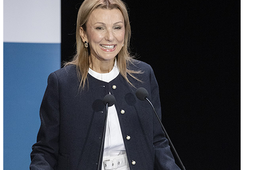 A woman speaks to the conference