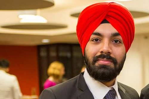 man in suit and turban smiling